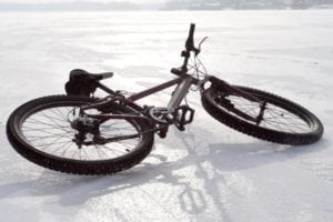 mountain bicycle lying on a iced river surface